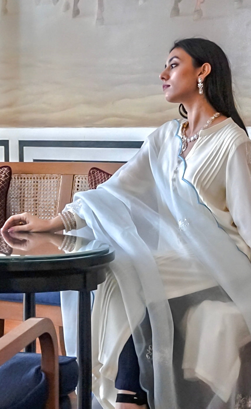 Stitched in cupro georgette, the pleated pin-tucked parallel panels run vertically along the front of the Kurta and also horizontally on the top back terrace.