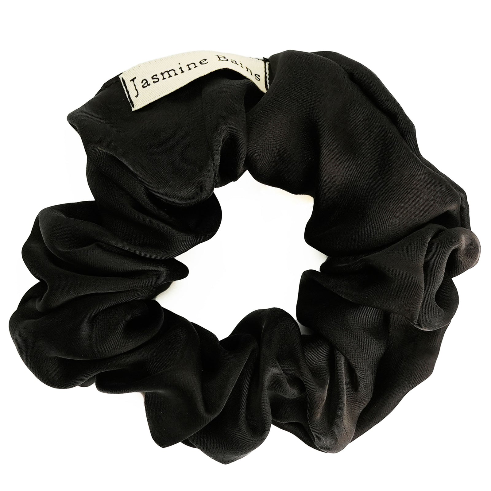 Elegant black silk scrunchie for ruffled hairstyles.