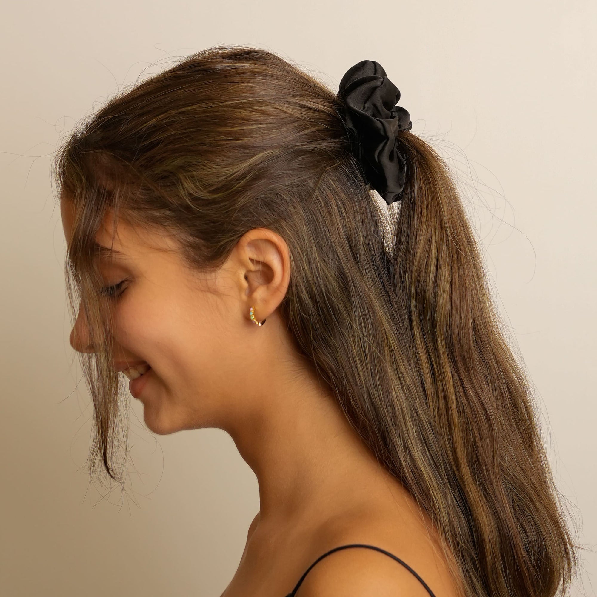 Black silk scrunchie designed for elegant ruffled hairstyles.