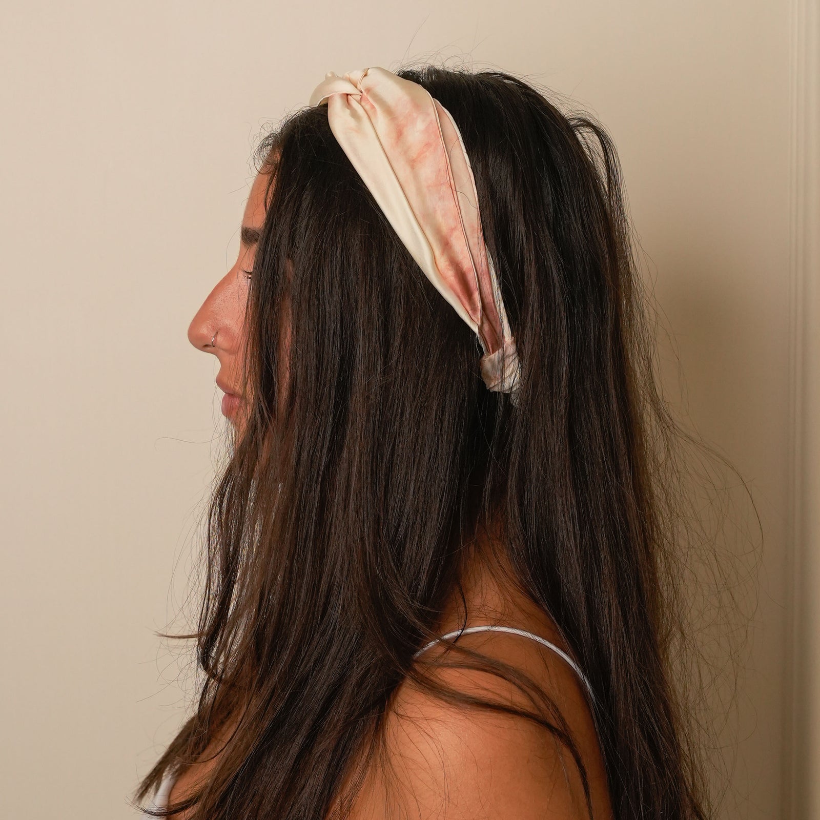 Elegant mulberry silk headband in marble-rust.
