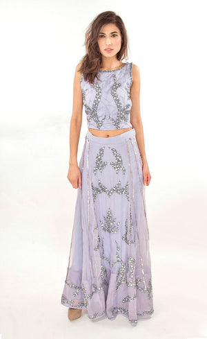 The muse here is wearing our lavender silk organza skirt-set. This skirt-set as a whole comprises of a sleeveless top and a flowy silk organza skirt which is intricately embroidered with our signature bead-work and sequins embroidery. This outfit is the one of the pieces you've been looking for the season because of it's perfect amount of flow and detailed embroidery providing you the elegance you've been looking for.