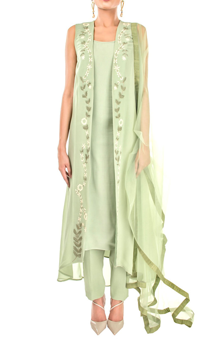 The muse here is wearing our light olive embroidered jacket suit set. This understated jacket suit set is enough to take your fashion game up this season. The front embroidery features a beautifully elegant zardozi embroidery all over the front opening panels on the outer jacket/gilet. This suit set features a round-neck slip underneath paired with crepe pants, and dupatta finished with a coordinating raw-silk border.