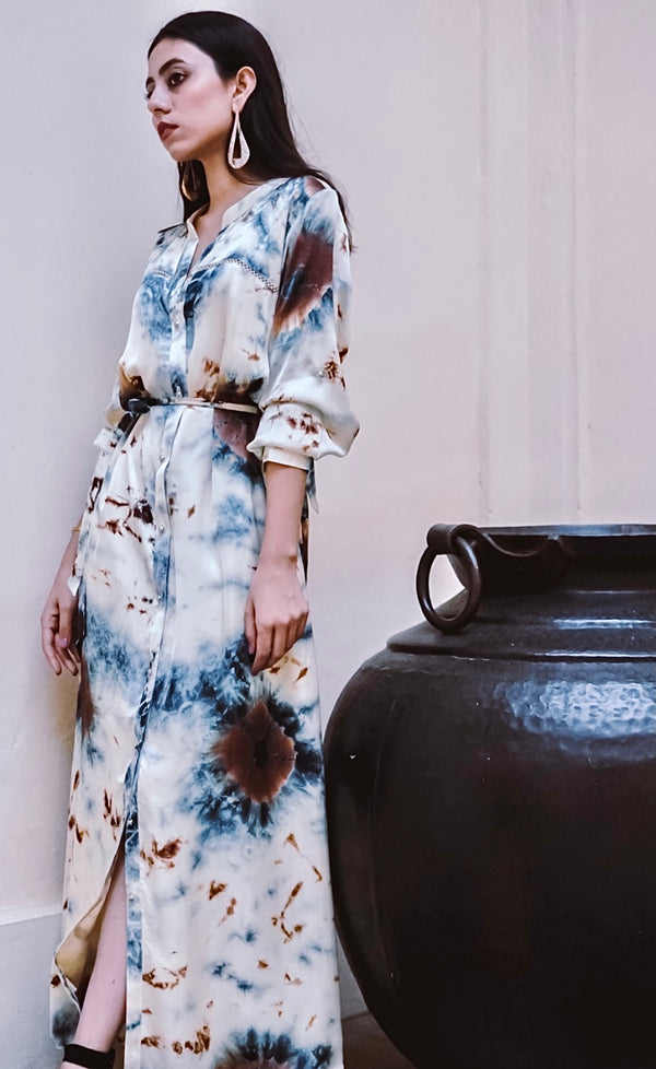 The blended blue and earthy coloured tie and dye dress represents the deep blue shades of the Mykonian sea along with the accents of the raw earthy beige brown. 