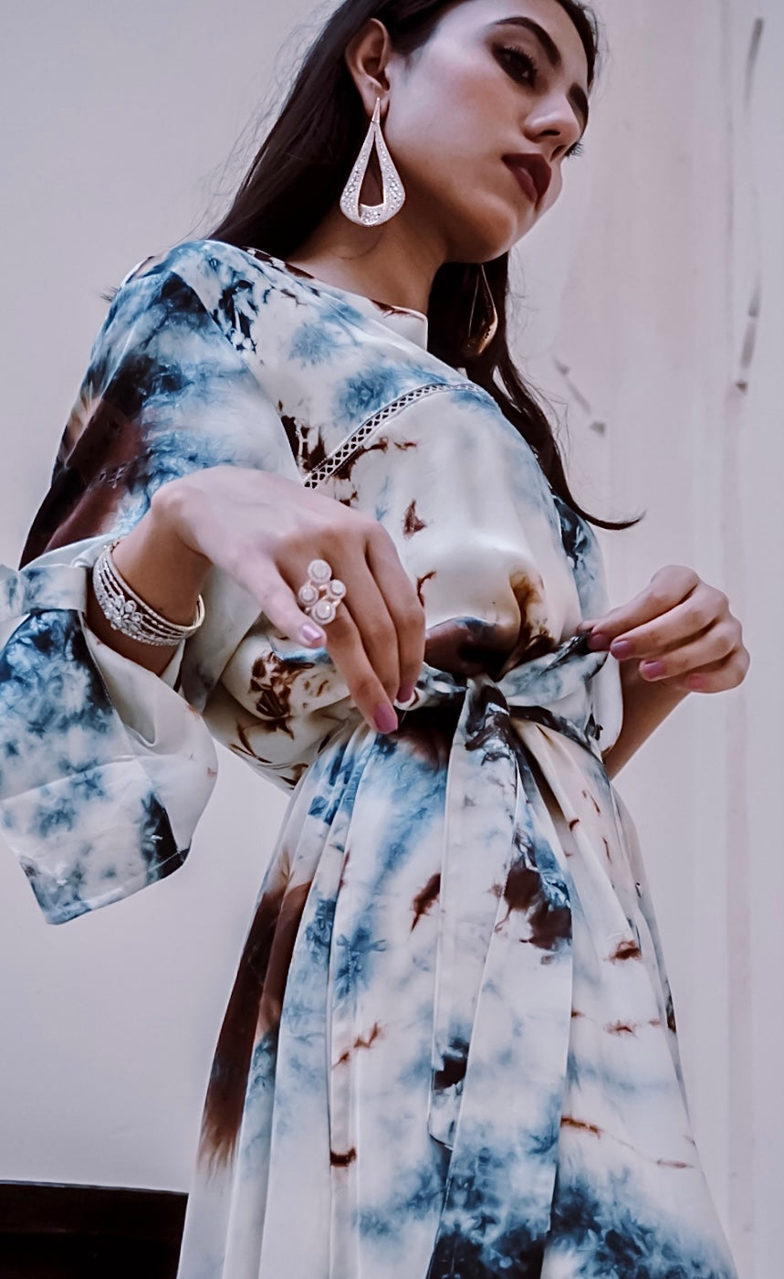 The blended blue and earthy coloured tie and dye dress represents the deep blue shades of the Mykonian sea along with the accents of the raw earthy beige brown. 