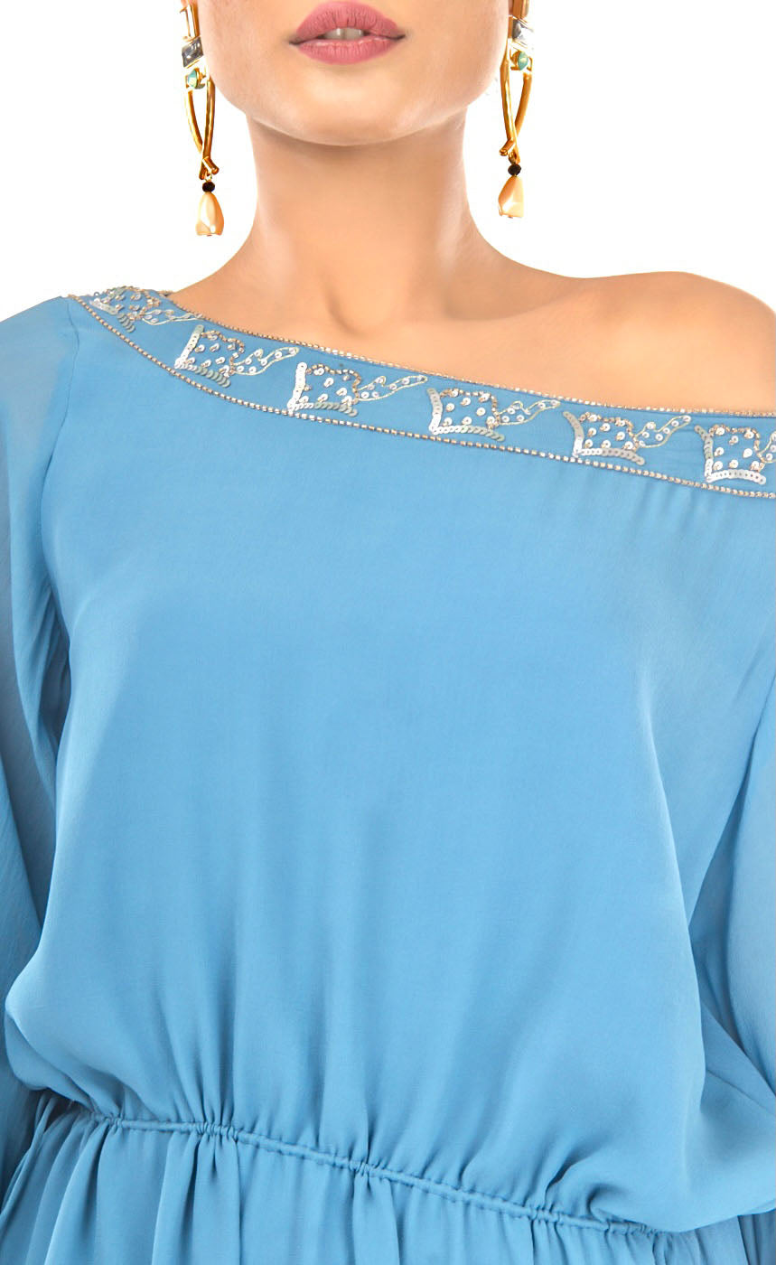 All eyes will be on you in this mykonos blue, exquisitely detailed one off shoulder dress. This dress features an elegant and effortlessly trendy one off shoulder neckline, carefully embroidered with beads and sequins giving a subtle and sophisticated look that exudes glamour. It has full sleeves that are gathered around the cuff, slightly ruched drawstring insertion along the waistline and a high slit at one of it's sides making this dress suitable for any occasion. 