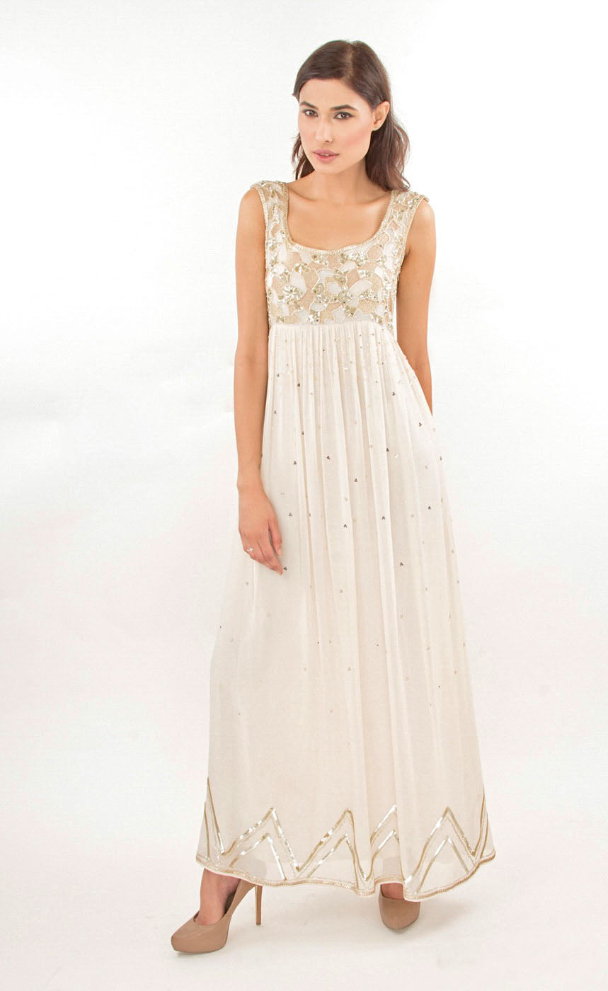 This is a simple and effortlessly elegant pearl silk beaded gown with a beautiful empire waist line partially embroidered with beads, sequins and gold work across the yoke area in the front as well as the rear. This flowy gown allows you to feel all the freedom around and is finished with gota appliqué work along the bottom flare. 