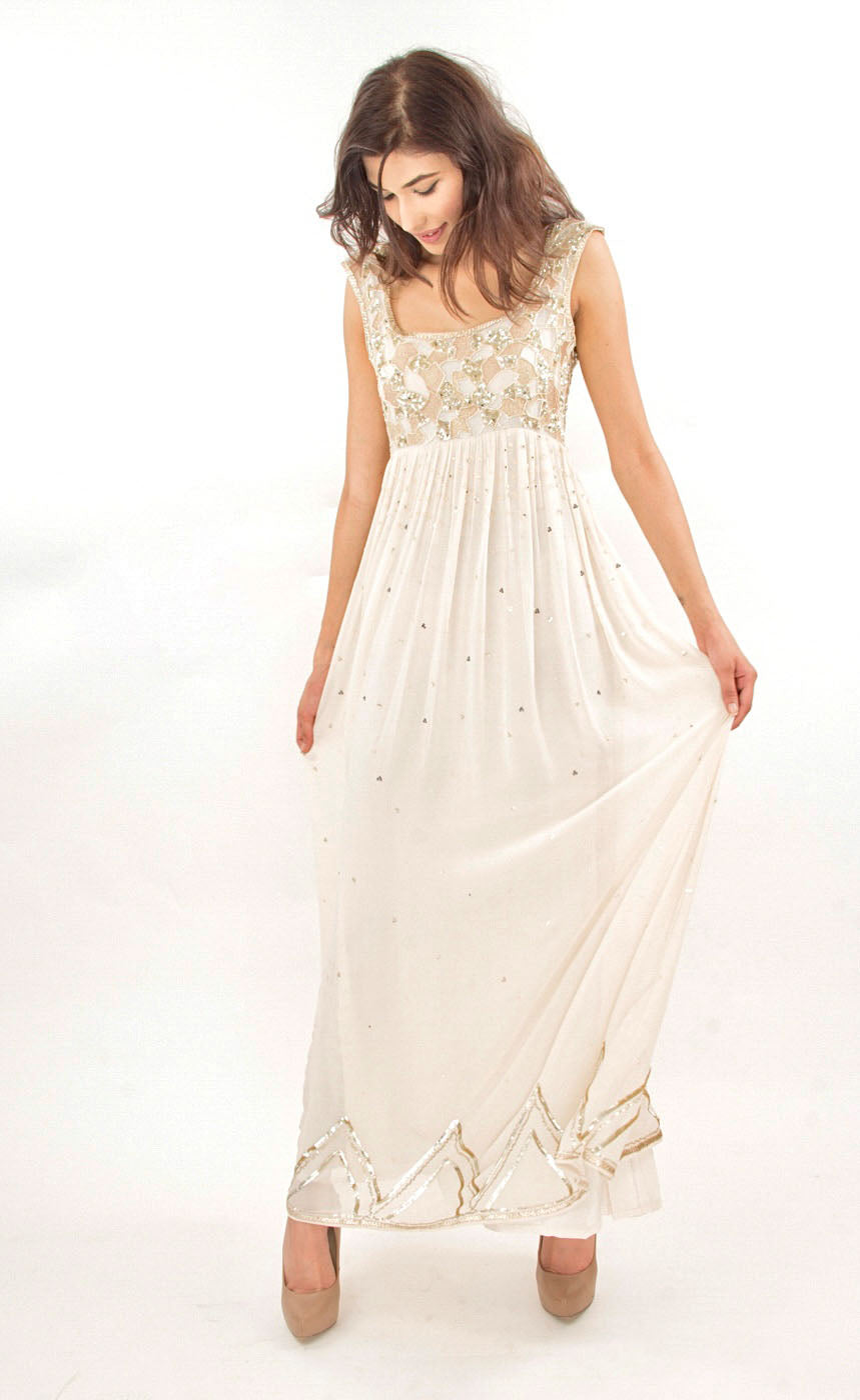 This is a simple and effortlessly elegant pearl silk beaded gown with a beautiful empire waist line partially embroidered with beads, sequins and gold work across the yoke area in the front as well as the rear. This flowy gown allows you to feel all the freedom around and is finished with gota appliqué work along the bottom flare. 