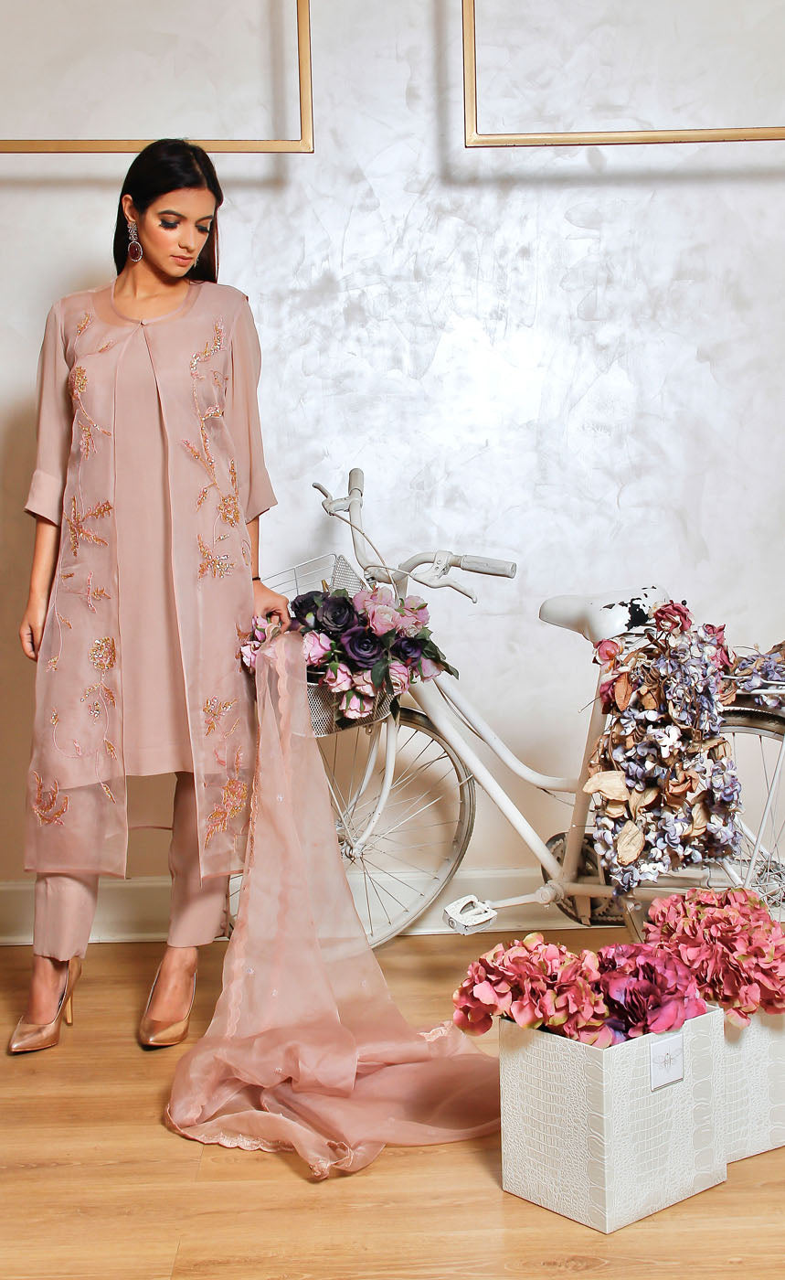 Handcrafted powder rose pink embellished jacket with knee length top with signature crepe buttoned trousers. 