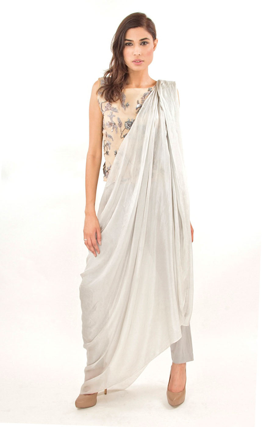 The muse here is wearing our silver grey ready to wear sari drape with trousers. It is a perfect look to spice up your traditional game to something really trendy. This comprises of a silk sari drape paired with a silk organza intricately embroidered crop top hand embroidered with silk threads, sequins, beads and silver grey work. The outfit is paired with slim crepe trousers. 