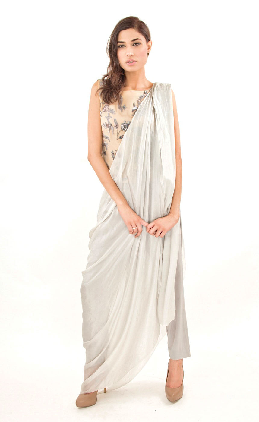 The muse here is wearing our silver grey ready to wear sari drape with trousers. It is a perfect look to spice up your traditional game to something really trendy. This comprises of a silk sari drape paired with a silk organza intricately embroidered crop top hand embroidered with silk threads, sequins, beads and silver grey work. The outfit is paired with slim crepe trousers. 