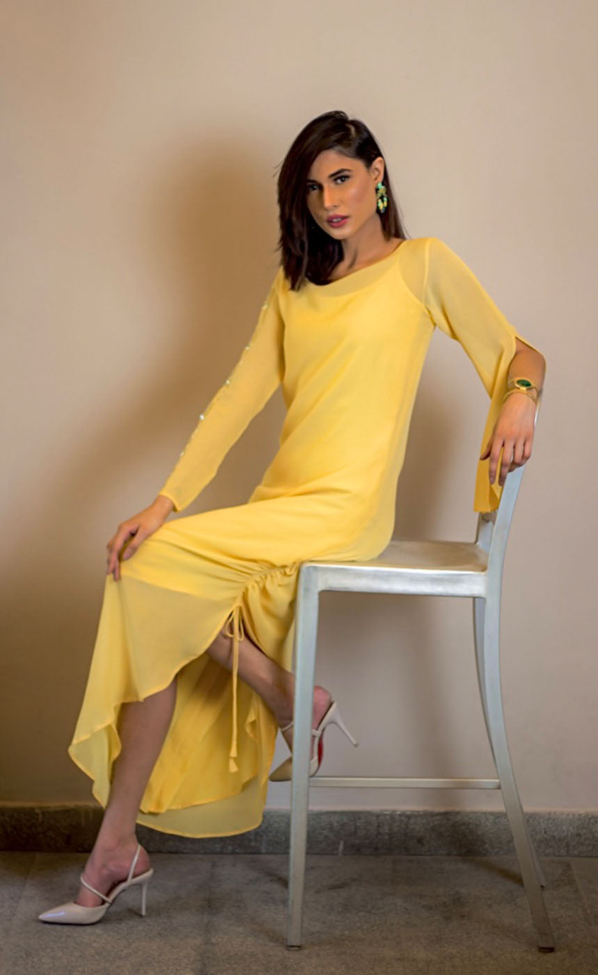 This is our tuscan yellow side drawstring dress which has all the flowy vibes which is a perfect dress for any event, bearing bead-work embroidery vertically on one sleeve and slit on the other to reveal your little glam and sparkly mood making it a beautiful lounge or an evening wear. The dress further has adjustable drawstring at one of it's sides providing a simple and elegant look.